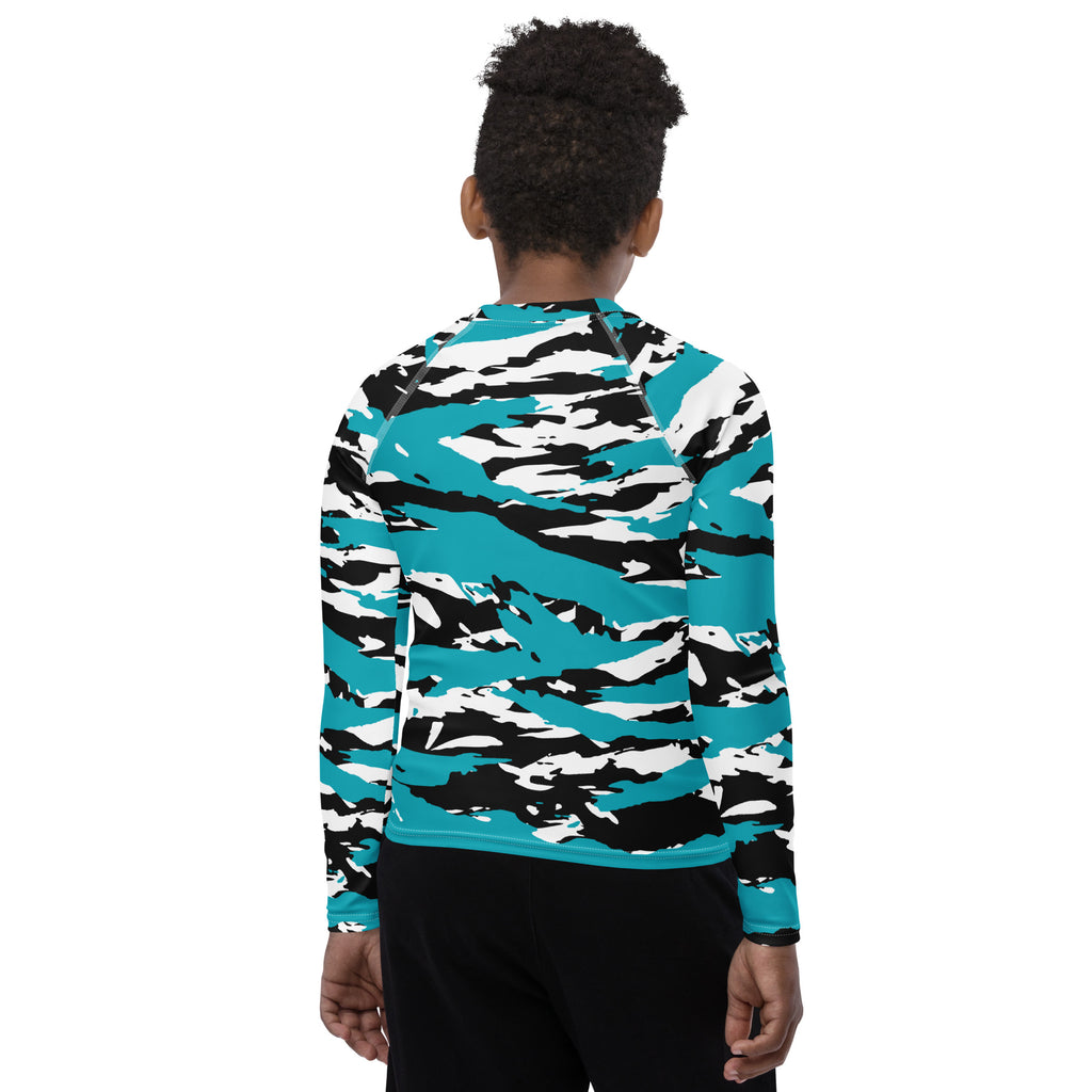 Athletic sports compression shirt for youth football, basketball, baseball, golf, softball etc similar to Nike, Under Armour, Adidas, Sleefs, printed with camouflage black, white, and turquoise colors.    