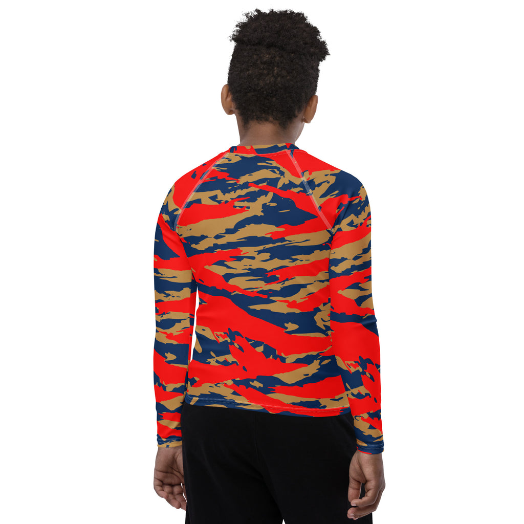 Athletic sports compression shirt for youth football, basketball, baseball, golf, softball etc similar to Nike, Under Armour, Adidas, Sleefs, printed with camouflage navy blue, gold, and red colors.  