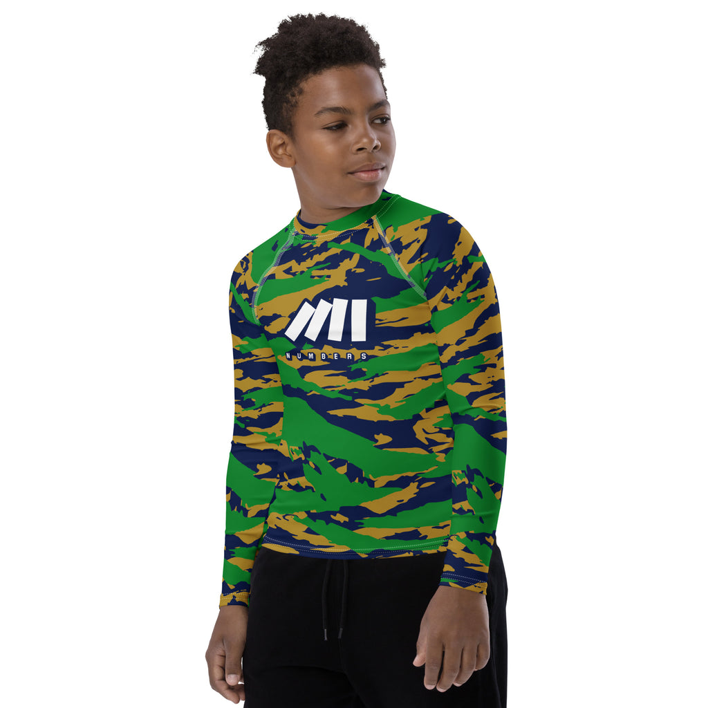 Athletic sports compression shirt for youth football, basketball, baseball, golf, softball etc similar to Nike, Under Armour, Adidas, Sleefs, printed with camouflage navy blue, green, and gold colors Notre Dame Fighting Irish.    