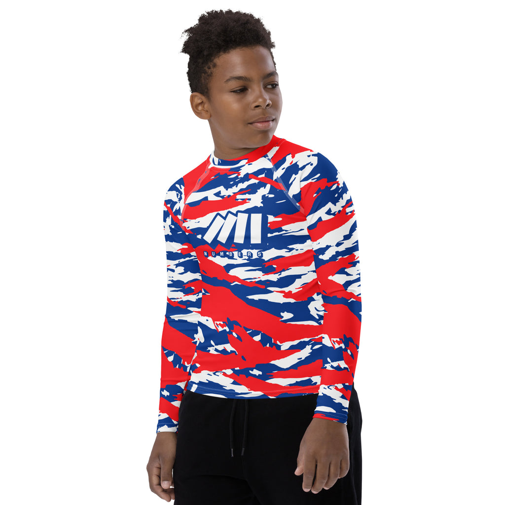 Athletic sports compression shirt for youth football, basketball, baseball, golf, softball etc similar to Nike, Under Armour, Adidas, Sleefs, printed with camouflage red, white, and blue colors Los Angeles Clippers. 