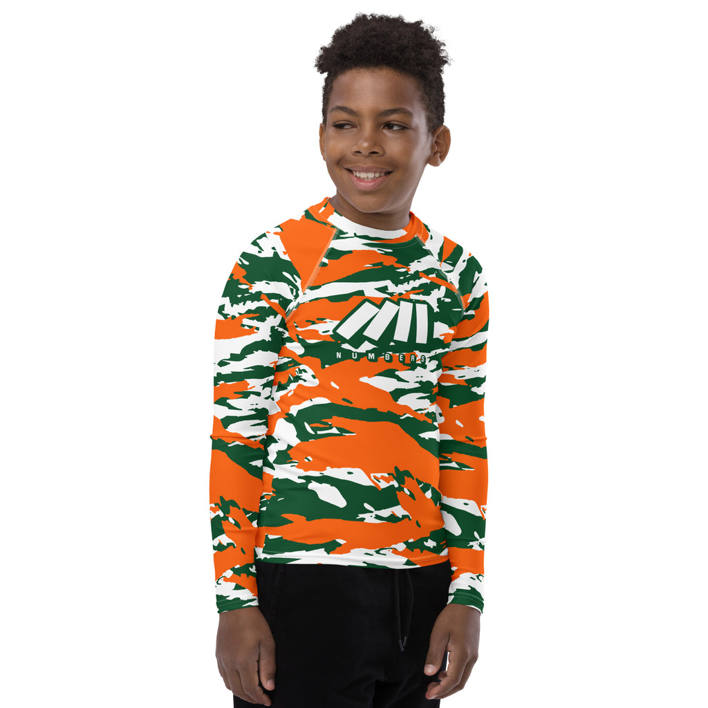 Athletic sports compression shirt for youth football, basketball, baseball, golf, softball etc similar to Nike, Under Armour, Adidas, Sleefs, printed with camouflage orange, green, and white colors University of Miami Hurricanes.  