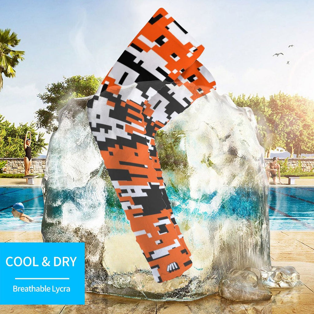 Athletic sports compression arm sleeve for youth and adult football, basketball, baseball, and softball printed with digicamo black, orange, and white colors. 